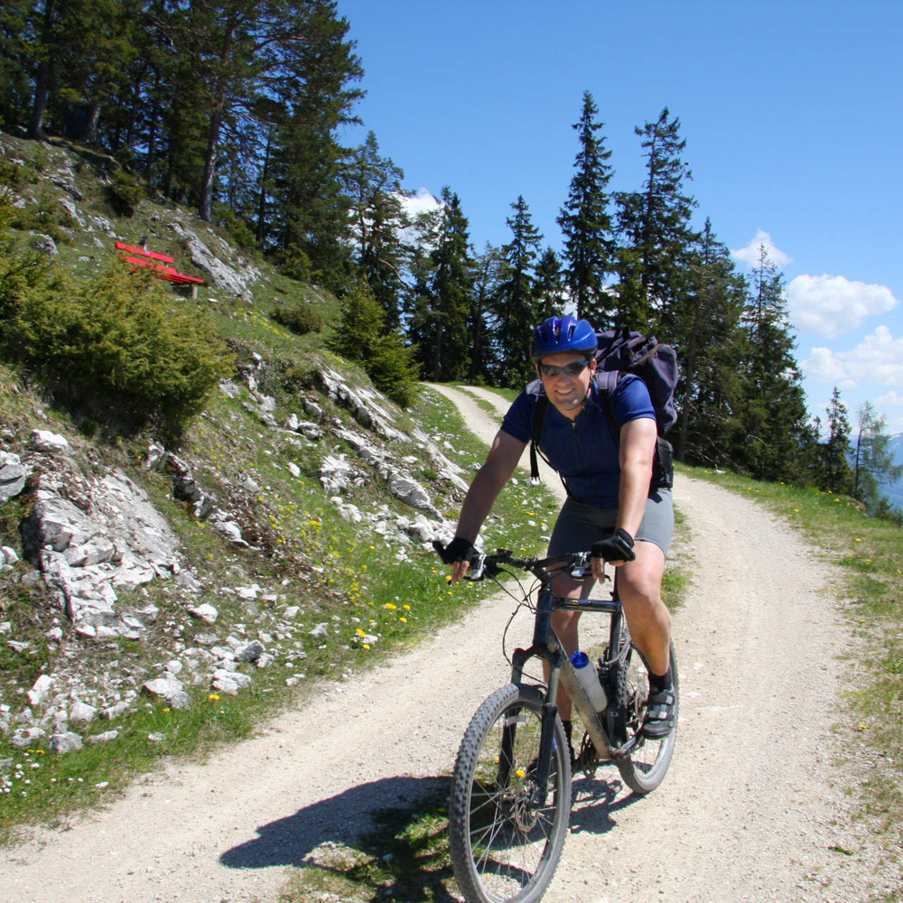 Ein Mann fährt mit dem Fahrrad einen Weg runter